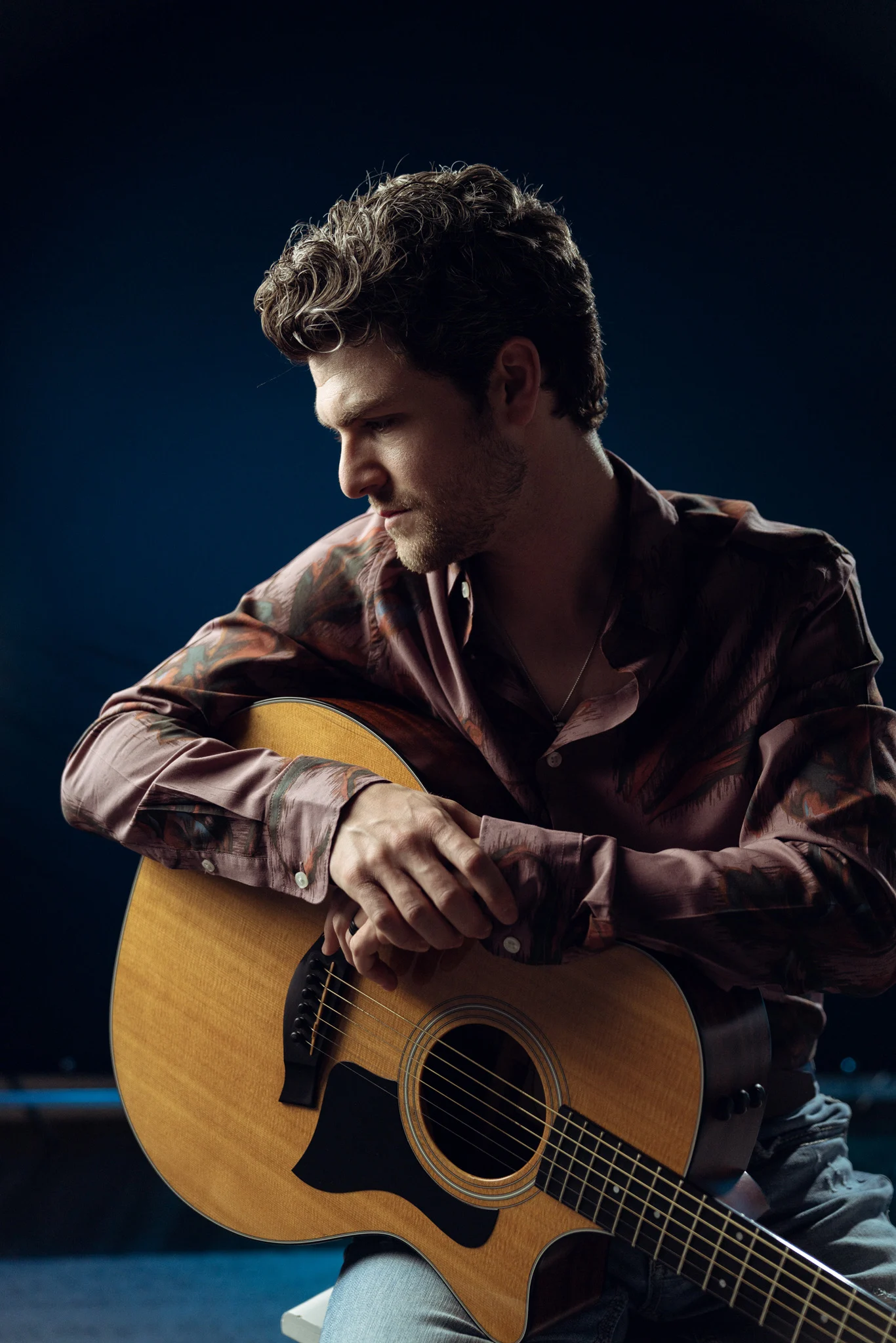Cory Jackson holding an acoustic guitar